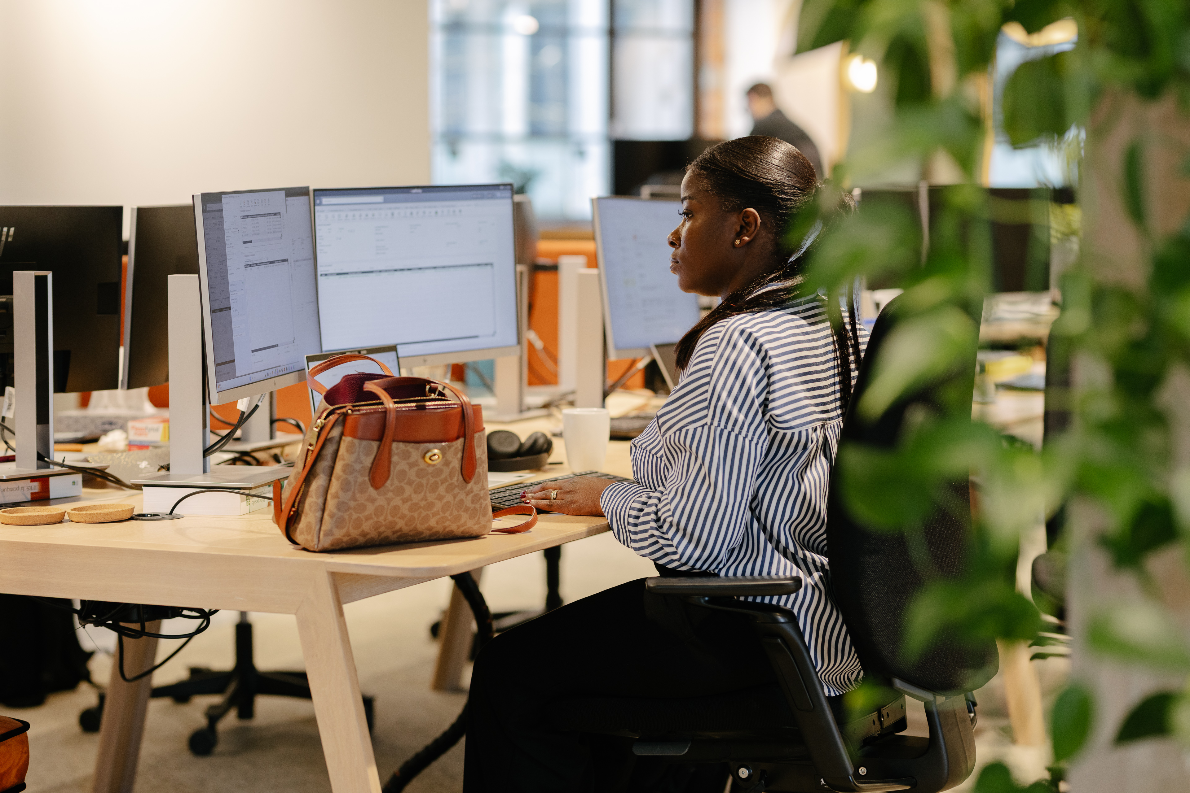 Employee working at her desk in an open-plan office