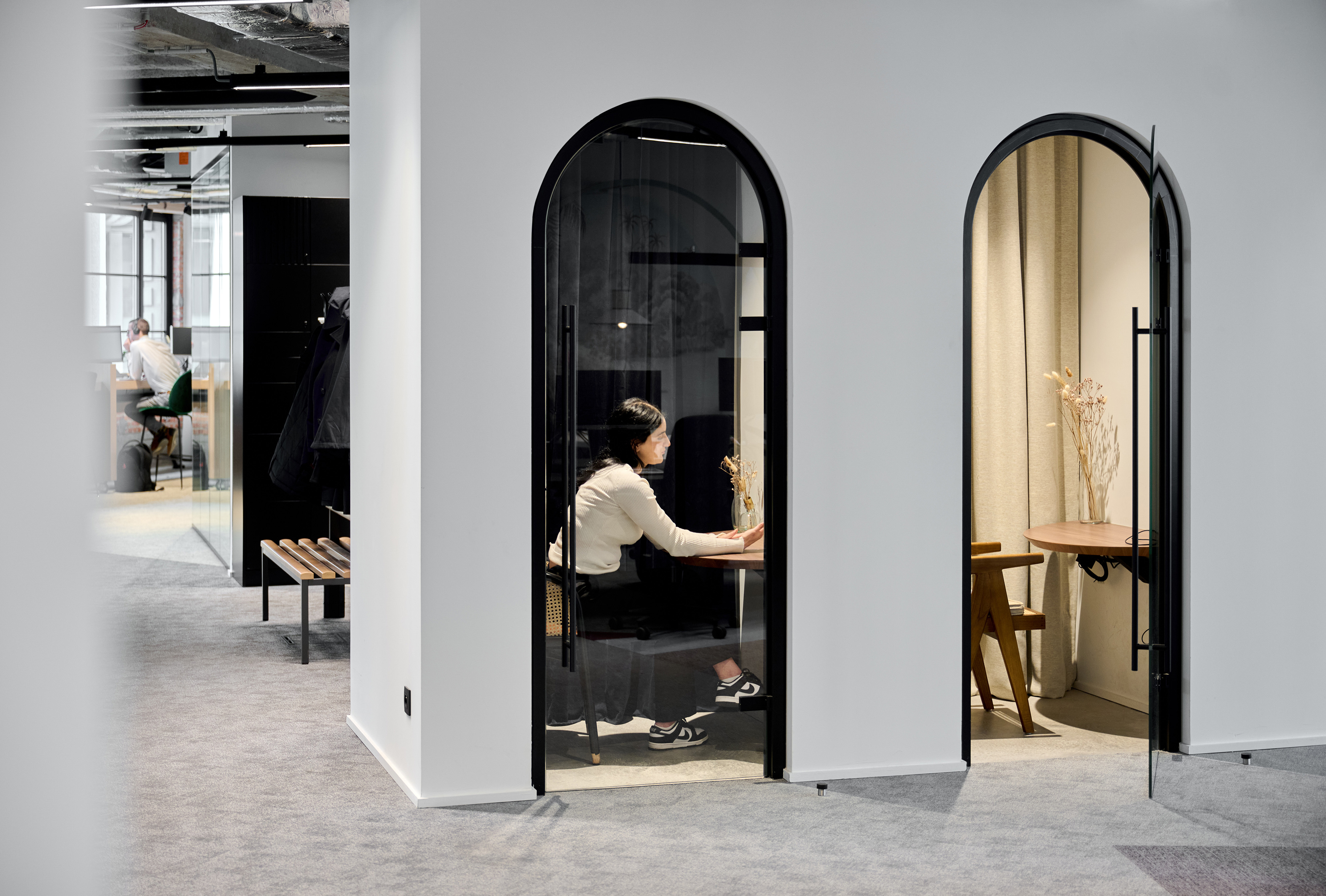 Enclosed focus booths beside an open-plan floor